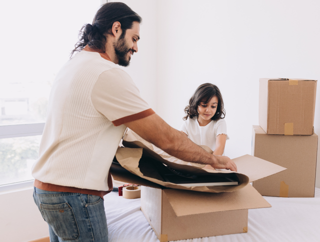 A father and daughter packing boxes