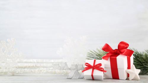 Christmas presents by a Christmas tree branch