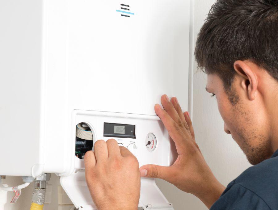A person checking the boiler