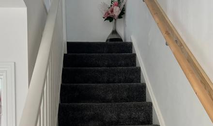 Stairs with a hand rail to the right