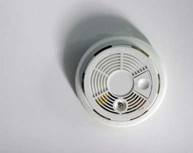 Image shows a fire alarm on a ceiling