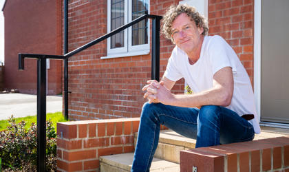 Man Sitting On His Doorstep