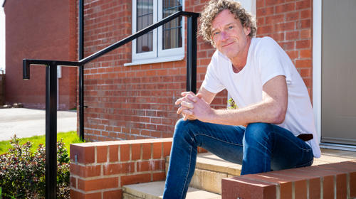 Man Sitting On His Doorstep