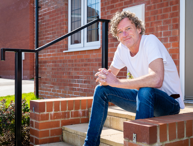 Man Sitting On His Doorstep