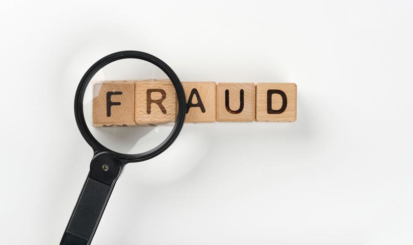 Magnifying Glass With Fraud Message