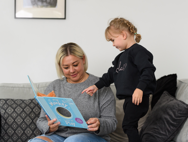 A mother reading a book with her daughter
