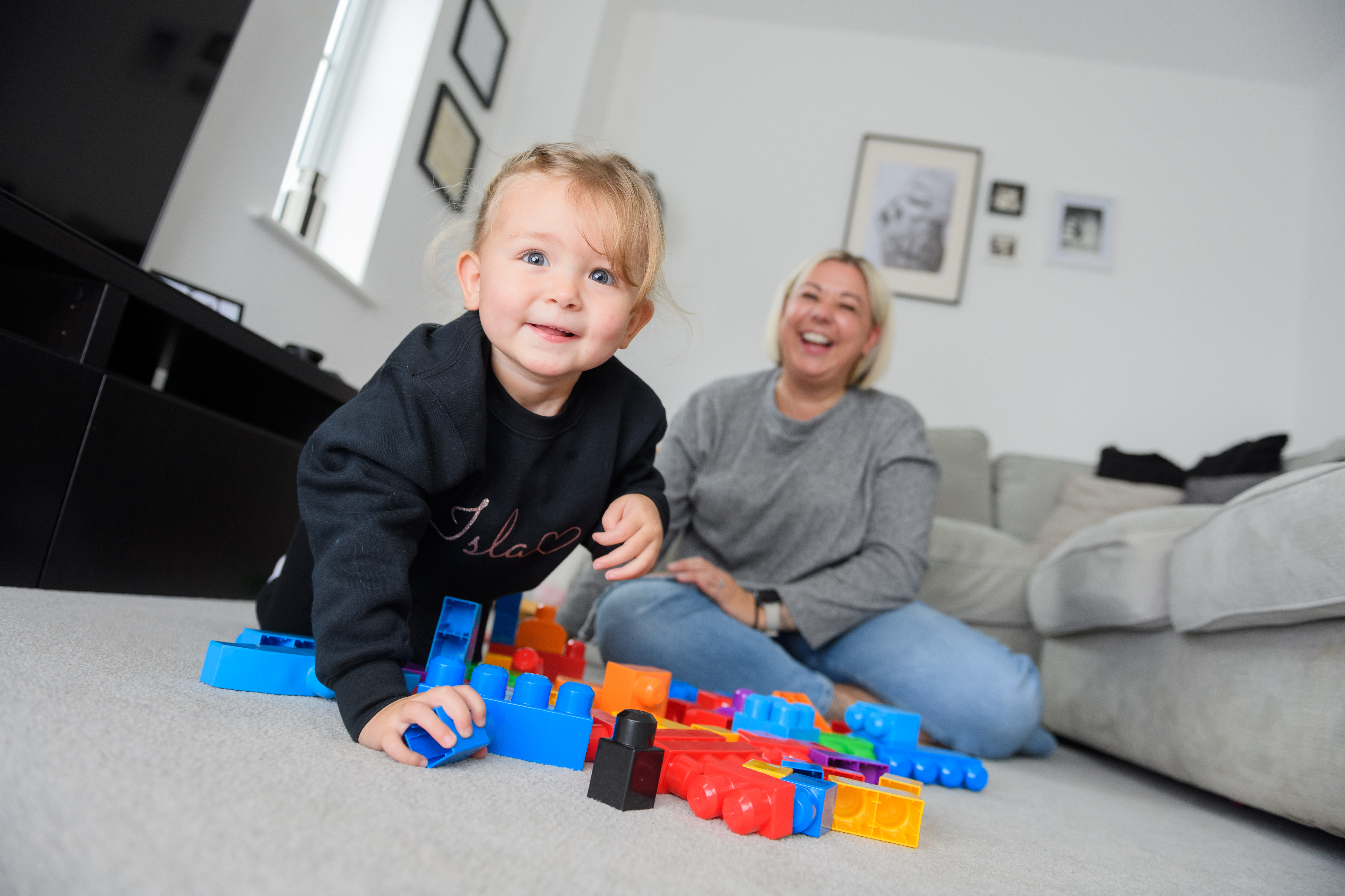 A tenant with her daughter playing with building blocks