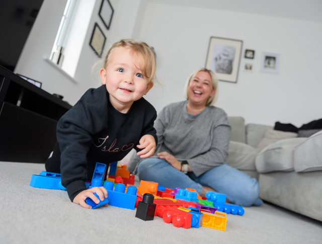 A tenant with her daughter playing with building blocks