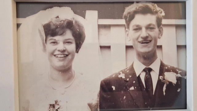 Black And White Picture Of Couple On Their Wedding Day Smiling To Camera