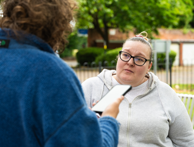 A tenant speaking to a Midland Heart employee