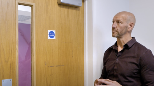 Midland Heart Employee Looking At A Fire Door