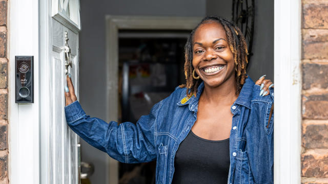 Tenant Standing In Her Doorway And Smiling