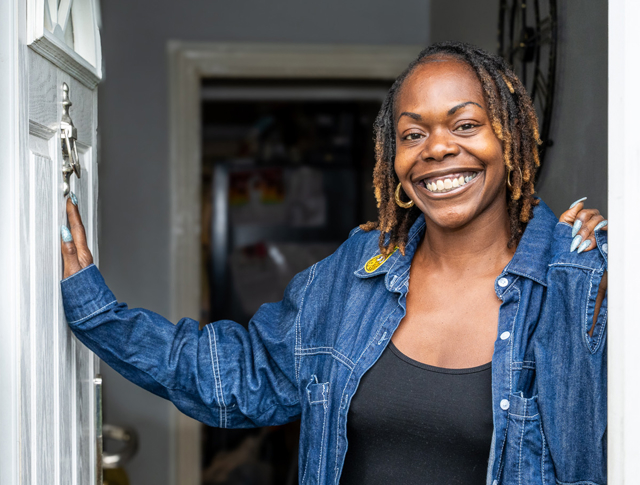 Tenant Standing In Her Doorway And Smiling