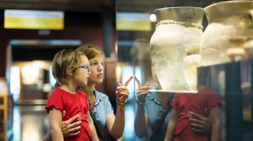 Mother And Little Girl Looking At A Museum Display
