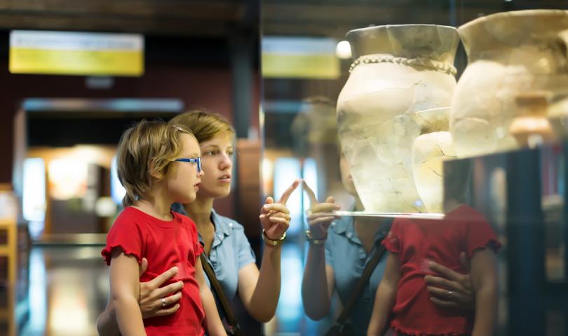Mother And Little Girl Looking At A Museum Display