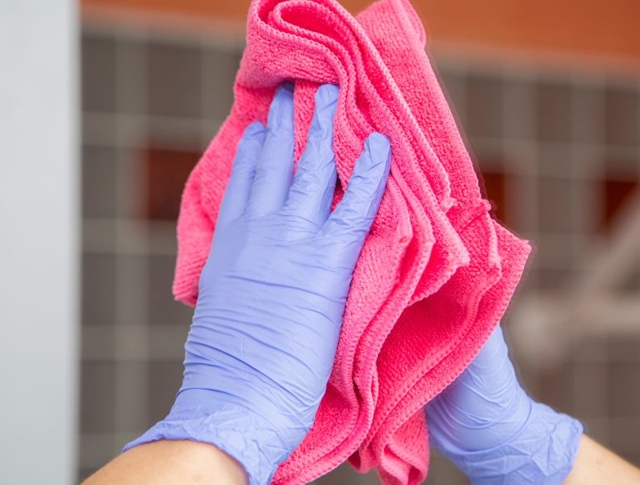 Someone wiping a mirror with a cloth