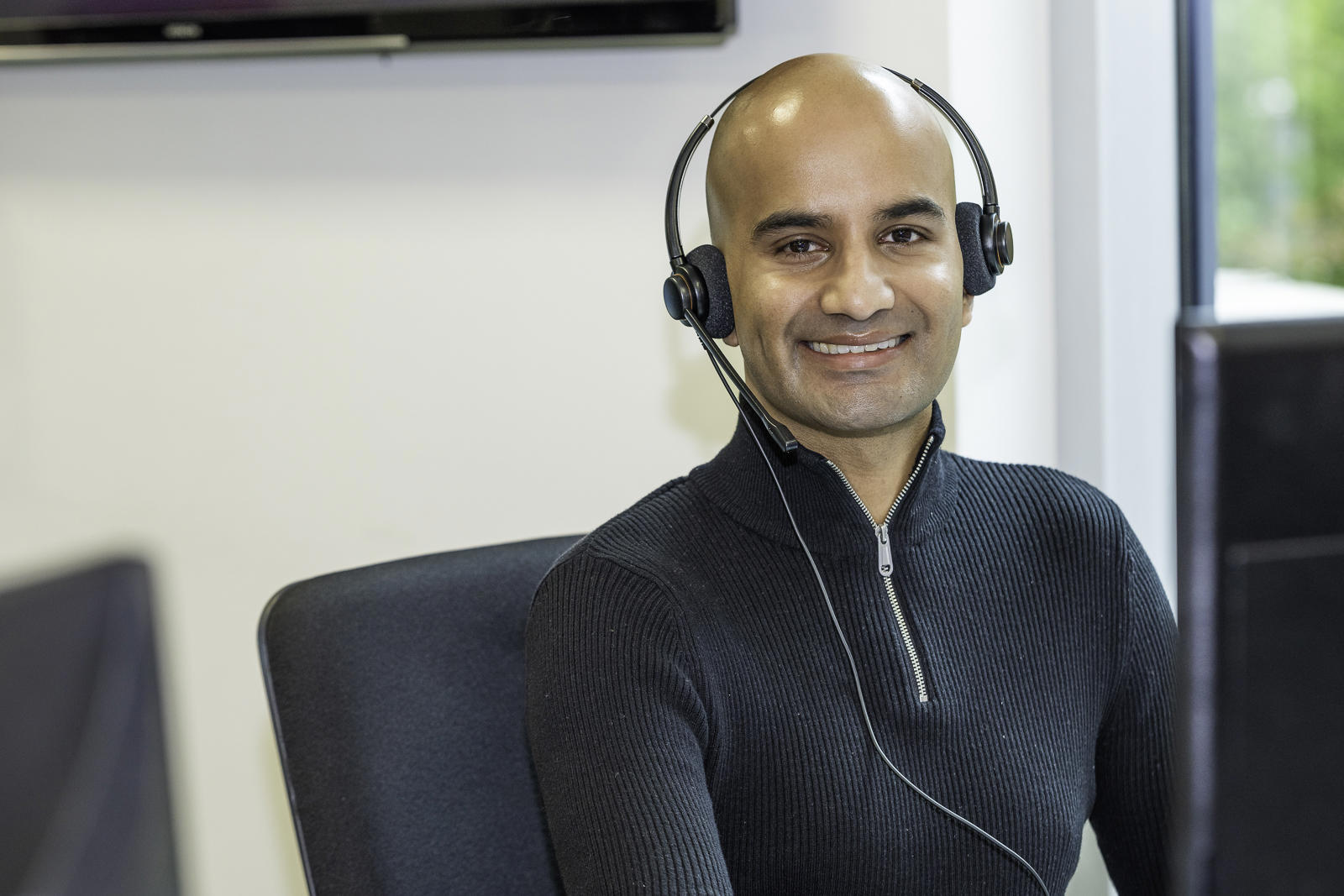 A Midland Heart employee wearing a headset at their desk