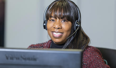 Hub Employee Wearing A Headset And Smiling