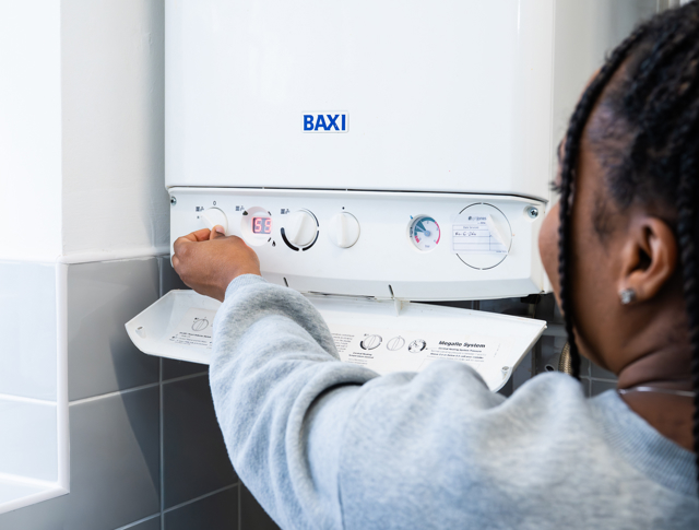 A Tenant Looking At Her Boiler