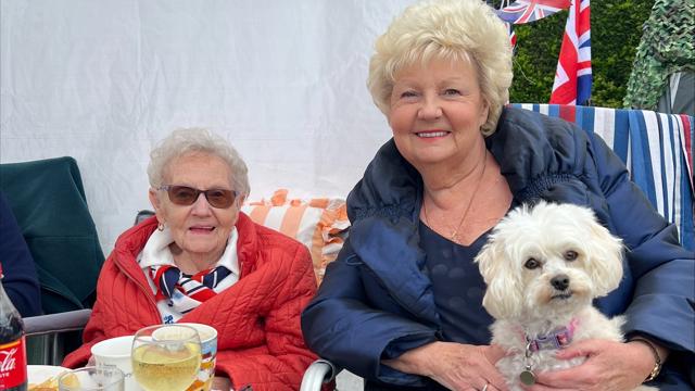 Residents Smiling For Camera With Dog