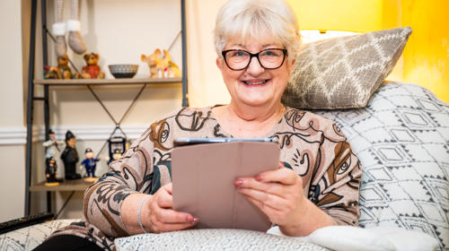 Woman With Glasses Looking At Her Tablet Computer