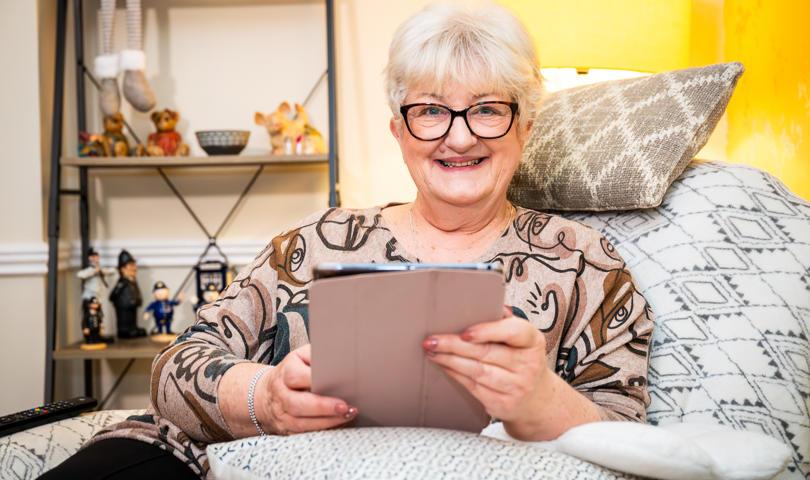 Woman With Glasses Looking At Her Tablet Computer
