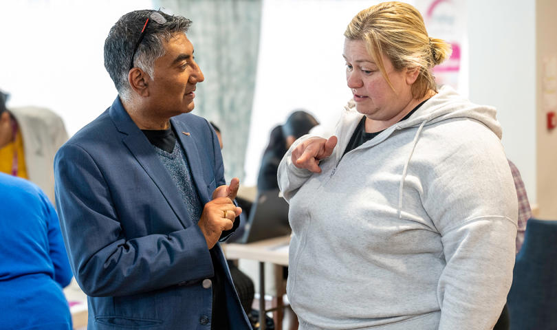 Resident Talking To A Midland Heart Employee In A Big Room