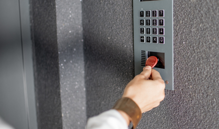 A tenant using their fob to enter an apartment block