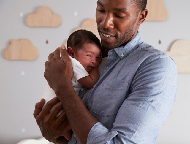 Man Holding Newborn Baby