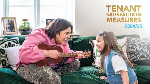 Photo Of Woman Sitting On Sofa Playing A Guitar To A Young Girl Both Are Smiling