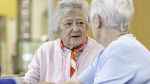 Two Elderly Women Speaking Together