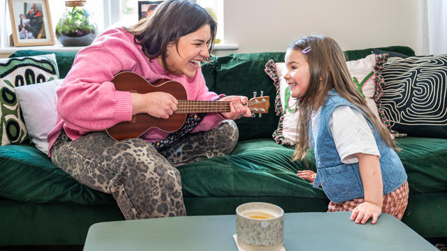 A mother playing music with her daughter