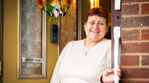 Woman Holding A Handrail At Her Front Door