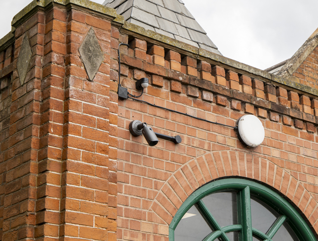 CCTV camera installed high on a wall